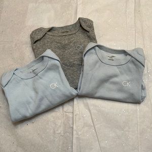 3 Calvin Klein onesies.